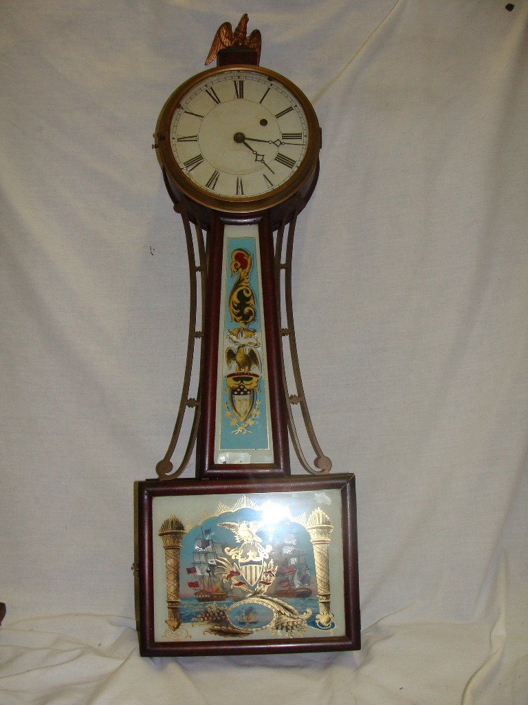 Tiffany & Co Reverse Painted Banjo Clock: 33 1/2" tall, 7 3/4" deep, there is some paint loss and minor damage to the case as pictured