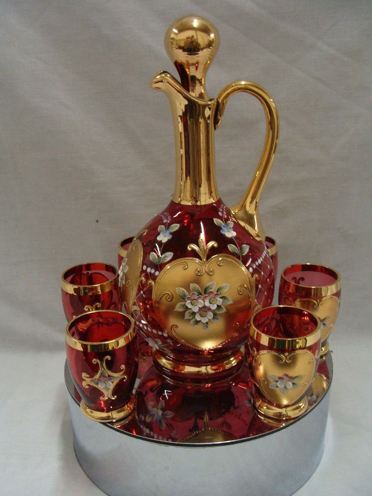 HandPainted Ruby Red Gold Encrusted Decanter and 6: Decanter is 9 1/2" tall and 11 1/8" with the stopper, , glasses are 2 3/4" with a design on each side