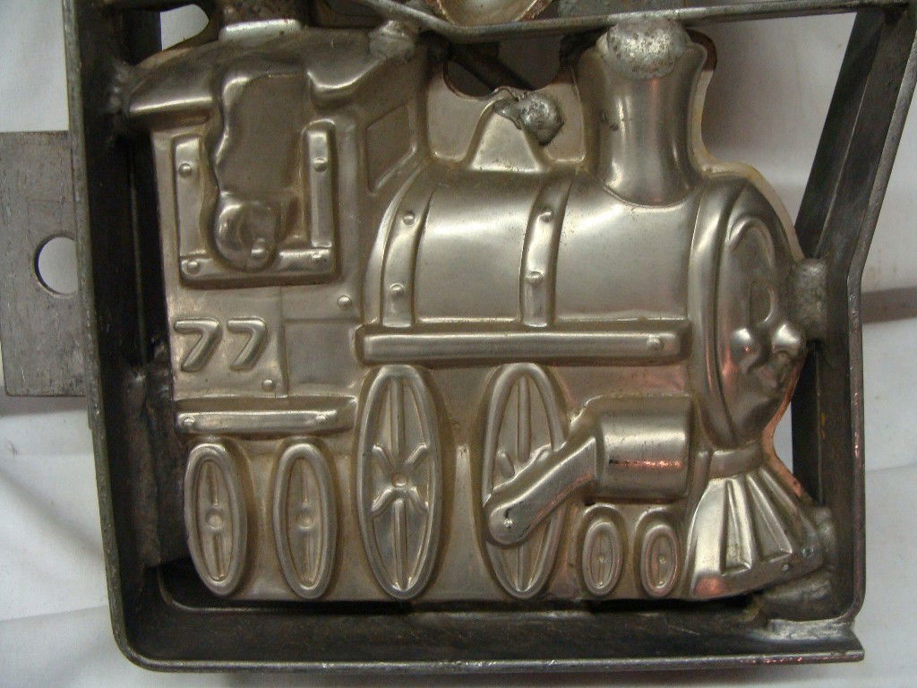 Pair of Large Hanging Double Framed TRAIN Locomoti: Lot consists of 2 hinged tray 77 Trains with face front design, each has two trains per mold, the bunny in the middle is one side only and does not have a matching top. Overall length is 15" x 6" x 1