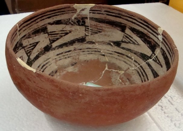 Prehistoric Hohokam Pottery Bowl with inner design: Prehistoric Hohokam Pottery Bowl with inner design bands. This bowl has been glued with several spots of plaster fill but no re-paint. It has bands of black and white geometric designs on the inside a