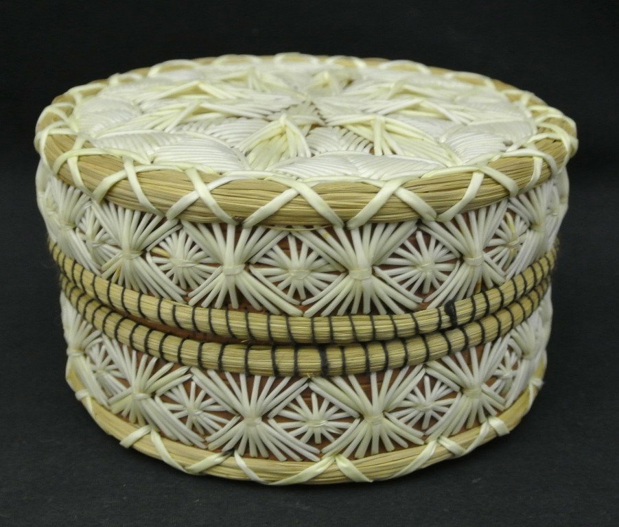Round Birch Bark Box with Quilled Design by Amelia: Round Birch Bark Box with Quilled Design by Amelia Trudeau. Measures 3’high x 5” in diameter with natural colored quill work designs on lid and sides. Rims are made from sweetgrass. One broken qui