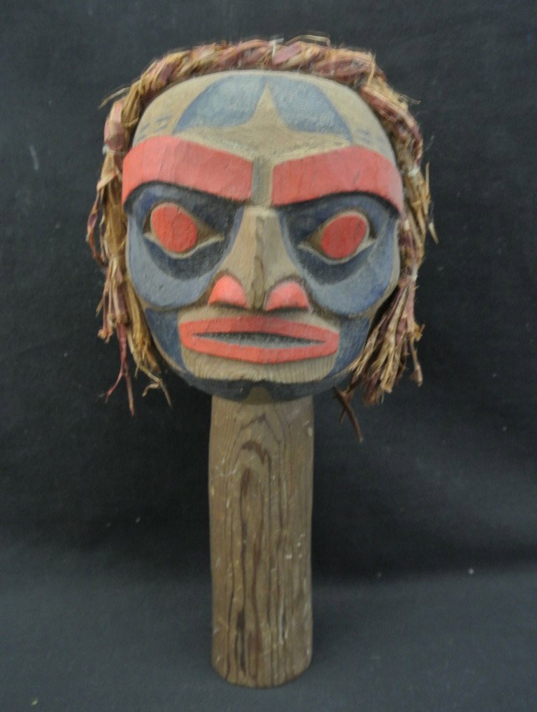 Northwest Carved Wooden Totem Rattle: Northwest Carved Wooden Totem Rattle. Hand carved and painted rattle with shaman’s face on one side and bear totem on the other. Shredded cedar bark used as hair. Perhaps Kwakuitl. Signed R.S. (Robe