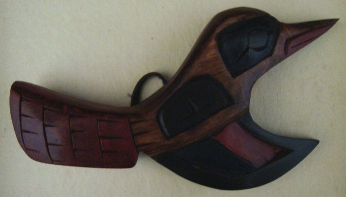 Northwest Coast Indian Carved Hummingbird Totem: This carved wood totem is painted red and black and measures 5 ¾" long. It has a leather hanger and is signed Ralph Shaughassy on the back.