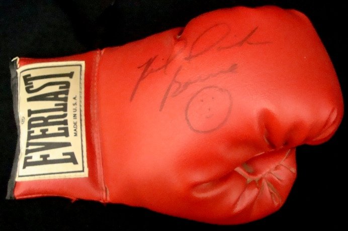 Riddick Bowe Autographed Everlast Boxing Glove: Riddick Bowe Autographed Everlast Boxing Glove; signed by the former two-time World Heavyweight Champion in black marker; inscribed with a smiley face under the signature; comes with an ALOA from JSA.