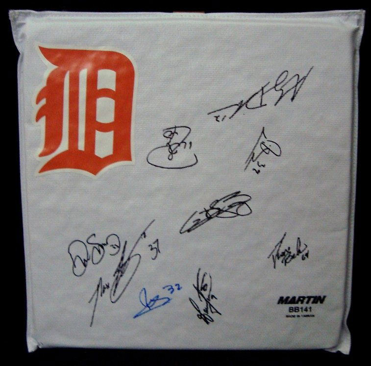 Detroit Tigers Autographed Base with (9) Signature: Martin BB141 Detroit Tigers Autographed Base; includes (9) signatures signed in black and blue sharpie marker; Tigers Logo displayed on base; signatures include Andy Dirks, Phil Coke, Ramon Santiago,