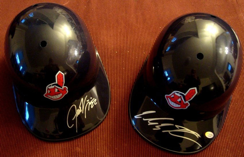 Carlos Santana & Jason Kipnis Signed Indians Batti: Lot of (2) Autographed Cleveland Indians Replica Batting Helmets; includes (2) Rawlings Fotoball Indians Replica Helmets with Indians logo on front and adjustable inside head straps; Carlos Santana au