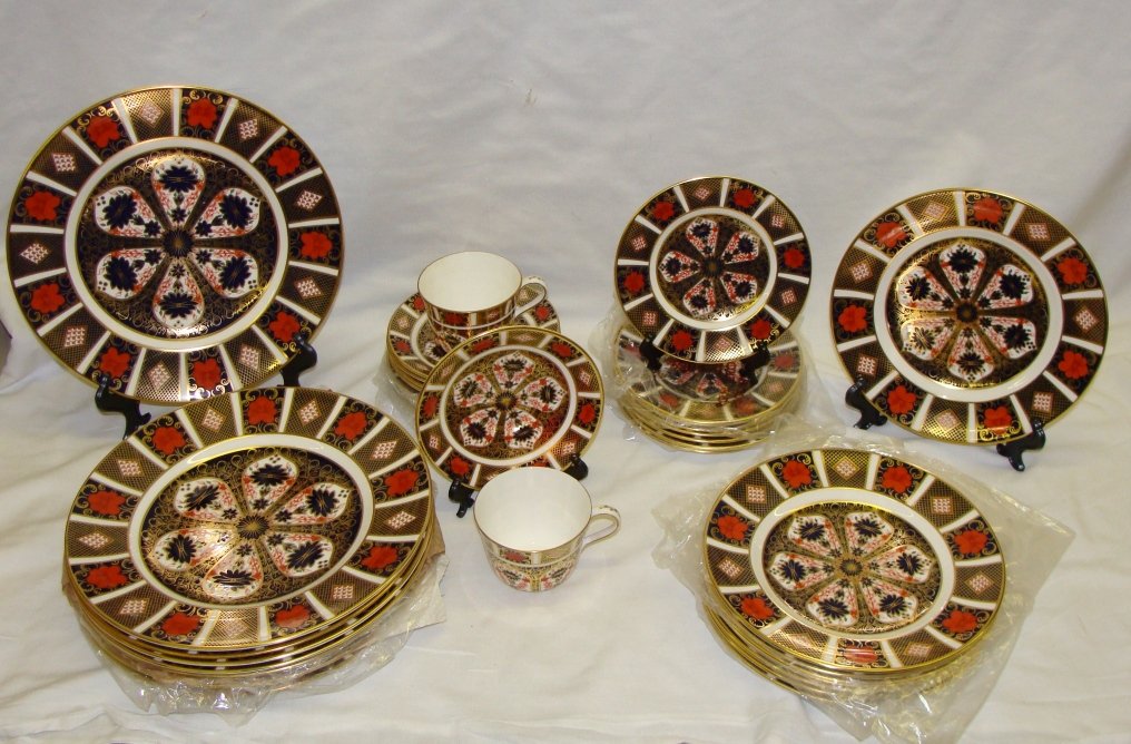40 Pc Old Imari Royal Crown Derby 1128 Service for 8: In the Old Imari 1128 Pattern from 1999, includes 8 Five Piece place settings, of Dinner Plate, Salad Plate, Bread & butter Plate, and cup & Saucer, many still with the otiginal plastice wraps, unused