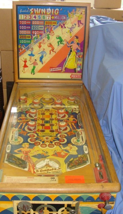 1953 Gottlieb Shindig Woodrail Pinball Machine: 1950's Shindig Woodrail Machine, Working condition, has not been serviced and contacts could use a cleaning, known that one contact has some issues. 1200 produced, 8 trap holes, reverse flippers.Artwo