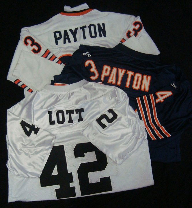 Ronnie Lott, Walter Payton Store Model Jerseys: Lot of (3) Store Model Football Jerseys; includes (2) Walter Payton jerseys and a Ronnie Lott jersey; Reebok Gridiron Classic Size L Chicago Bears Throwback Jersey; Mitchell & Ness 1991 Throwback Walt