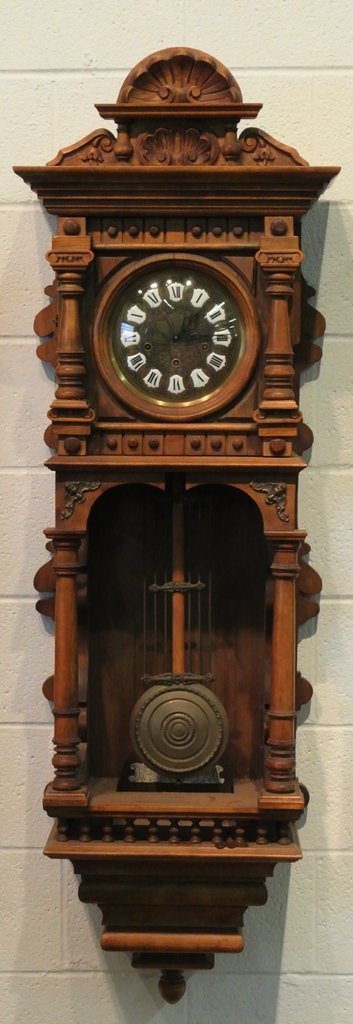 Giso Clock Co. Walnut Wall Clock: Non-Working with magnificent case that measures 55x19". Key wind that affects the running of the clock needs repair.