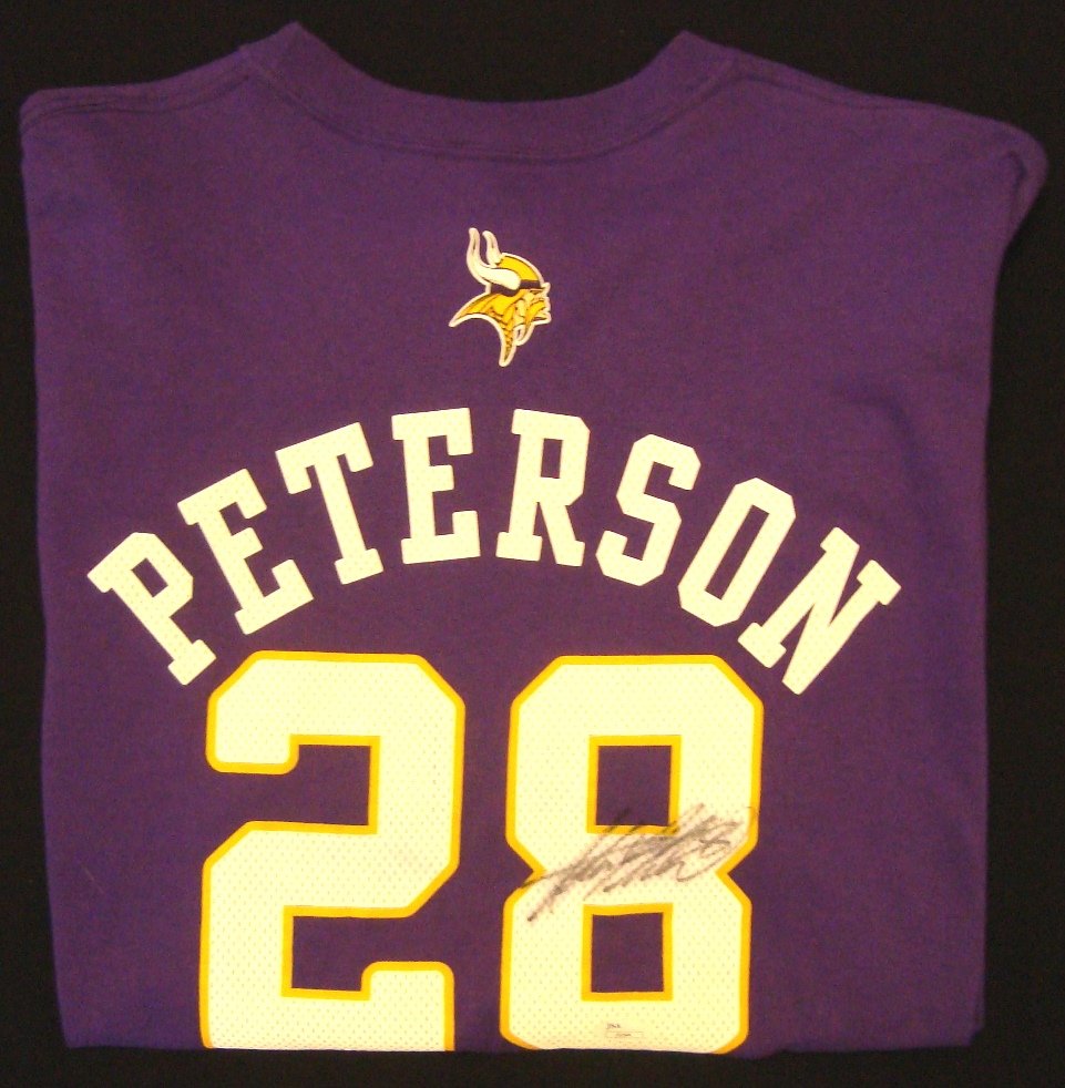 Adrian Peterson Autographed Vikings T-Shirt, JSA: Adrian Peterson Autographed Vikings T-Shirt; bright purple Reebok Size XL Vikings t-shirt signed by Peterson on the back in black sharpie marker; nice signature by the 5x All-Pro; comes with a Basic C