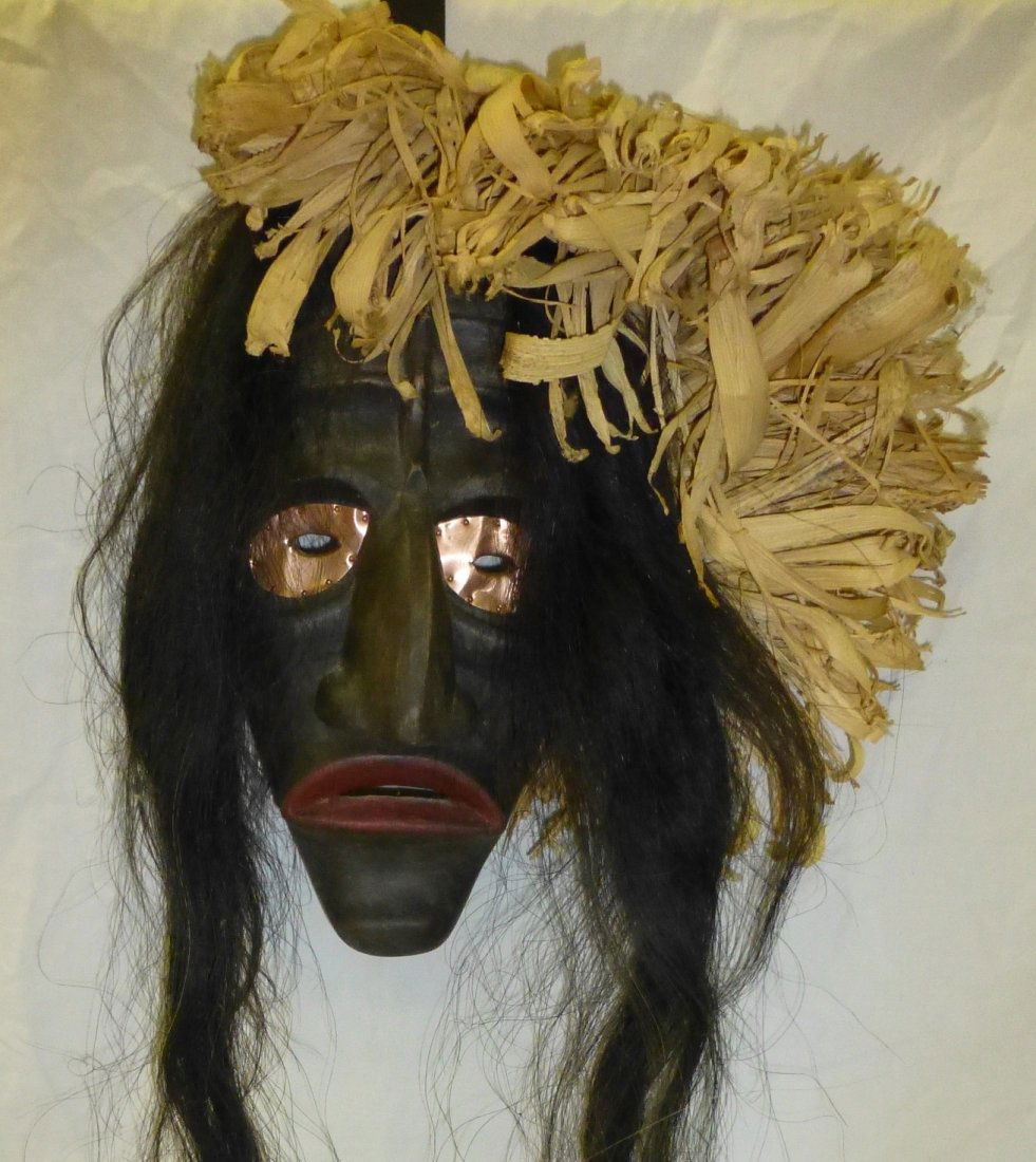 Cayuga False Face Harvest Mask by J.E. Thomas: Cayuga False Face Harvest Mask by J.E. Thomas. Unusual carved wood mask with horse hair and copper eyes. Corn Husks attached to one side. Circa 1970’2/80’s. Wood mask measures 11.5” long x 6.5��