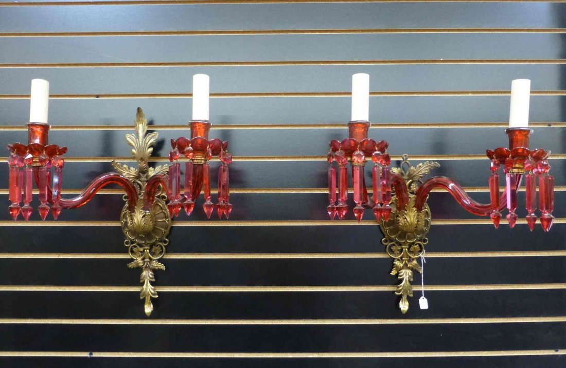 Oscar Bach Ruby Red Glass Prism Wall Sconces: Signed Oscar Bach. Each has a 17" span, the one complete one is 18" tall, the other is missing part of the top. 26/40 red prisms are present, some with chips.