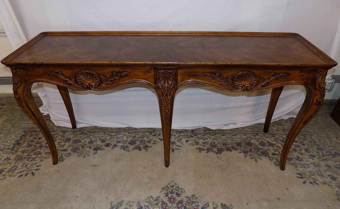 Henredon Sofa Table: Lovely Henredon sofa table that has an "antiqued" finish. The piece is 56" wide, 27" tall and 17" deep. Nice carvings on cabriole legs