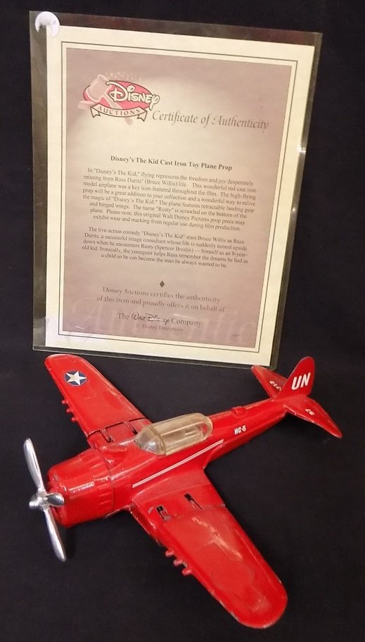 Prop Metal Plane from the Disney movie 'The Kid': Prop Metal Plane from the Disney movie 'The Kid' Starring Bruce Willis. Plane is marked 'Rusty' on the undercarriage and comes with letter from Disney Auctions.