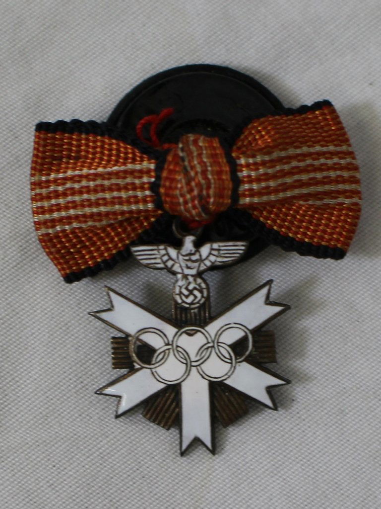 1936 German Berlin Olympics Organizer Sterling Lapel: Very rare, sterling and enameled lapel pin giver to Nazi members that helped organize the 1936 Berlin Olympics. Marked on the back .935 and Gebr. Godet & Co. Berlin. Excellent overall condition.