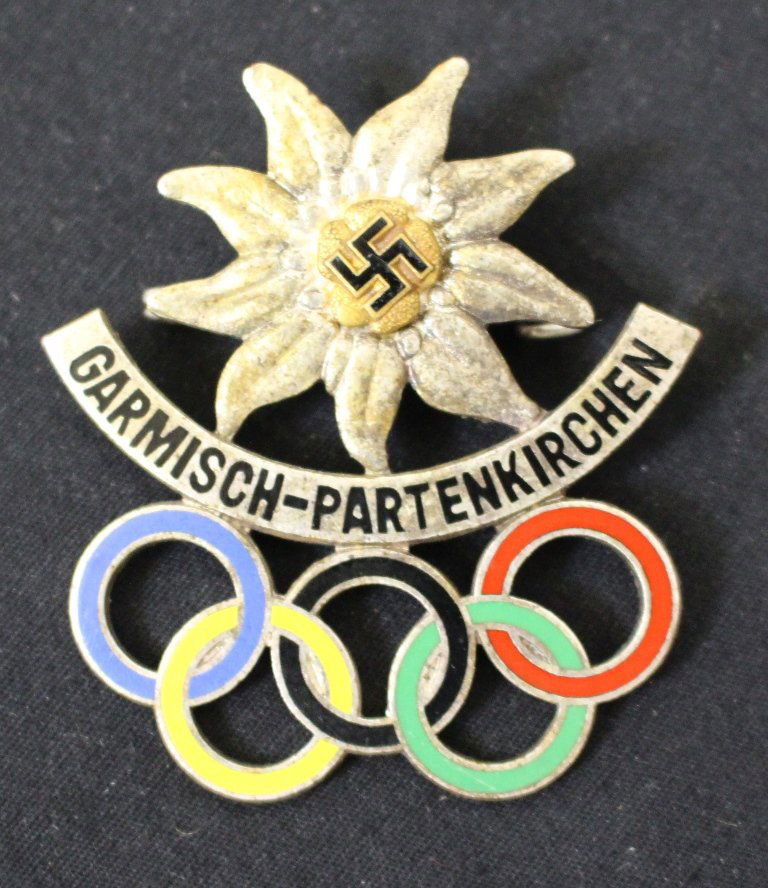Scarce 1936 Winter Olympics Garmisch-Partenkirchen: Here is a beautiful pin that was evidently sold at the Olympic Winter Games in 1936. It bears the edelweiss Alpine flower with swastika and has the 5-ring Olympic symbol all in different enamel colors