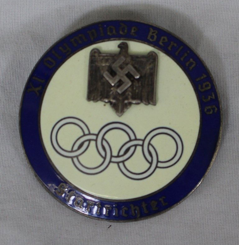1936 Berlin Olympics Startrichter (Start Judge) Pin: Olympic Games 1936, official start judges badge â€žStartrichter". Large silver plated badge with m/c enamel, mounted Reichs Eagle and Swaztika. Size 4.9cm, slightly tarnished, excellent overall co