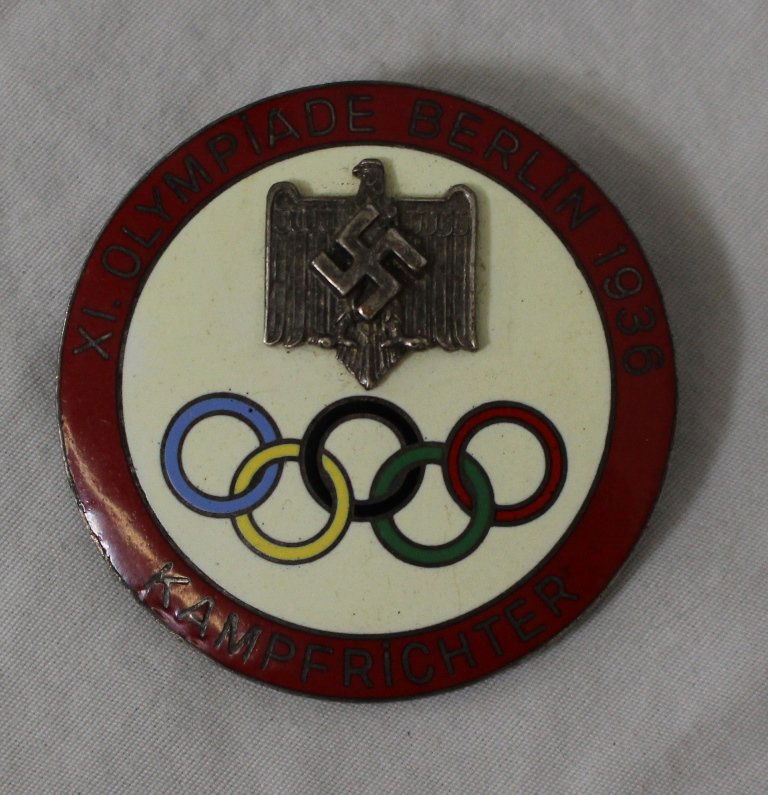 1936 Berlin Olympics Kampfrichter (Judge) Pin: Olympic Games 1936, official judges badge â€žkampfrichter". Large silver plated badge with m/c enamel, mounted Reichs Eagle and Swaztika. Size 4.9cm, slightly tarnished, excellent overall conditio
