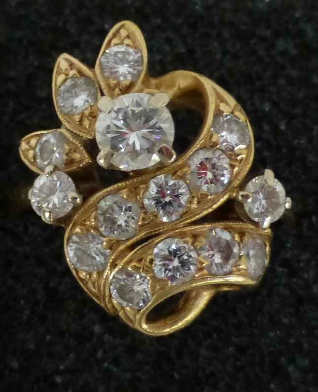 14K Gold 15 Diamond Cocktail Ring sz 7.5: Lovely ring set in 14k gold, features one large raised diamond round solitaire, with two smaller raised solitaires, with a ribbon of gold and 12 set in diamonds. The face of the ring is 3/4" x 5/8" at