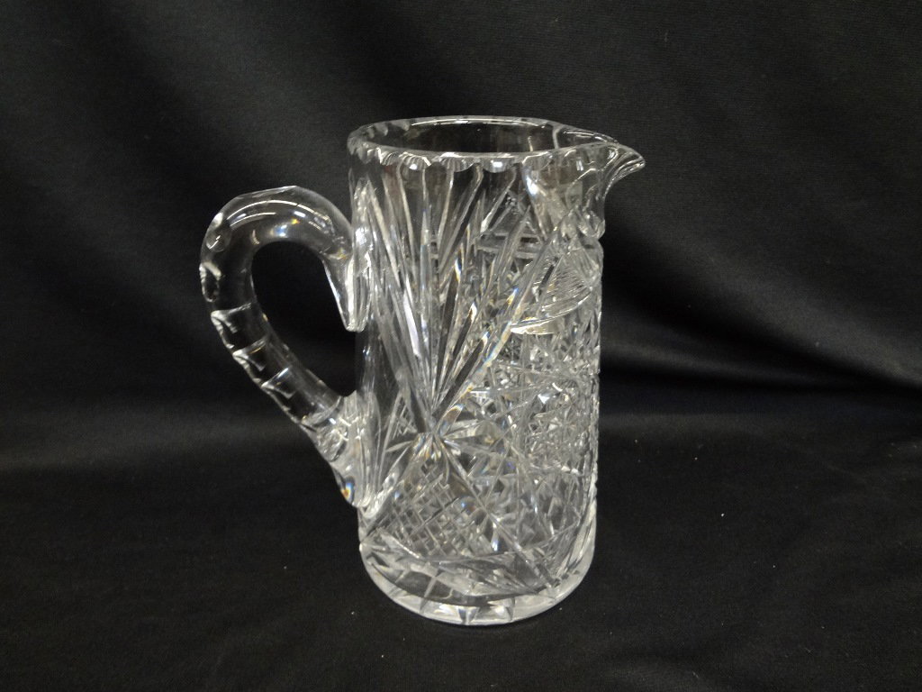 American Brilliant Cut Glass Pitcher Starburst Pattern: American Brilliant Cut Glass Pitcher Starburst Pattern: A lovely ABC Glass Pitcher. Stands 8 inches tall. There is a small chip out of the spout of the pitcher.