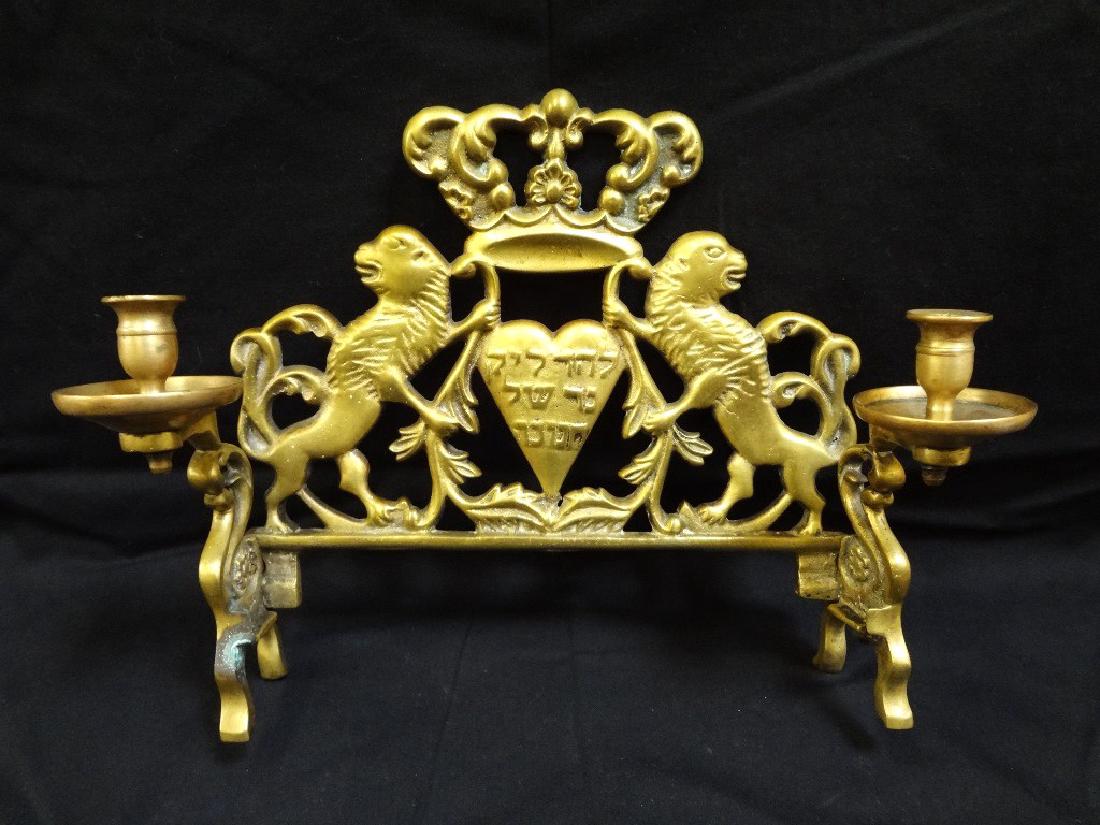 19th century Brass Menorah Lion Motif: 19th century Brass Menorah Lion Motif: (2) lions holding crown and heart with Hebrew Characters. 12 inches wide, 9 inches tall, 4 inches deep.