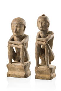 Pair of rice gods - Philippines - Ifugao: wood, blackish brown patina, strongly encrusted, male/female, classic posture, remains of fibre (head of the female figure), slightly dam., crack, abrasion of paintH: 41 cm (male)/43,5 cm (female),