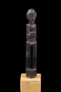 Anthropomorphic miniature figure - Indonesia - Borneo,: wood, dark brown patina, rising from long legs, stocky upper part of the body, small base;the lower end might once have been carved with an eyelet so that the figure originally could have been used