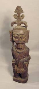 Sitting ancestor figure "adu zatua" - Indonesia - Nias: wood, middle brown patina, geometrical facial features with beard, fanciful headgear, paint rubbed off, insect caused damageH: 105 cm; B: 25 cmProvenance:August Flick, Cologne, GermanyLit.: Newton,