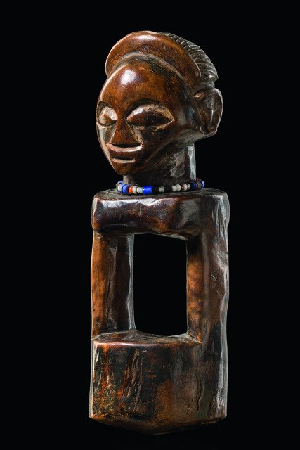 Divination instrument "kashekesheke" - D. R. Congo,: wood, stained brown patina, string of miniature glass beads, characteristic form, opening in the head for insertion of magical substances, slightly dam., abrasion of paint, base; Luba diviners use "ka