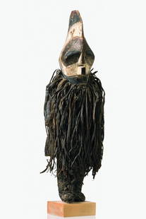 Mask dancer - D. R. Congo, Songe: wood, kaolin, black and brown pigments, separate worked arms, netted costume, animal skin loincloth, broad leather belt, wearing a "kifwebe" mask in male form "kilume" with high crest, provided with t