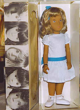 70_16" Sasha in Polka dot dress, Made in England: 16" Sasha, box label reads "116S Honey Blonde, Party, Made in England". Sasha dressed in blue polka dot on white dress, white socks, leather snap shoes. Blue eyes, near mint condition in original box