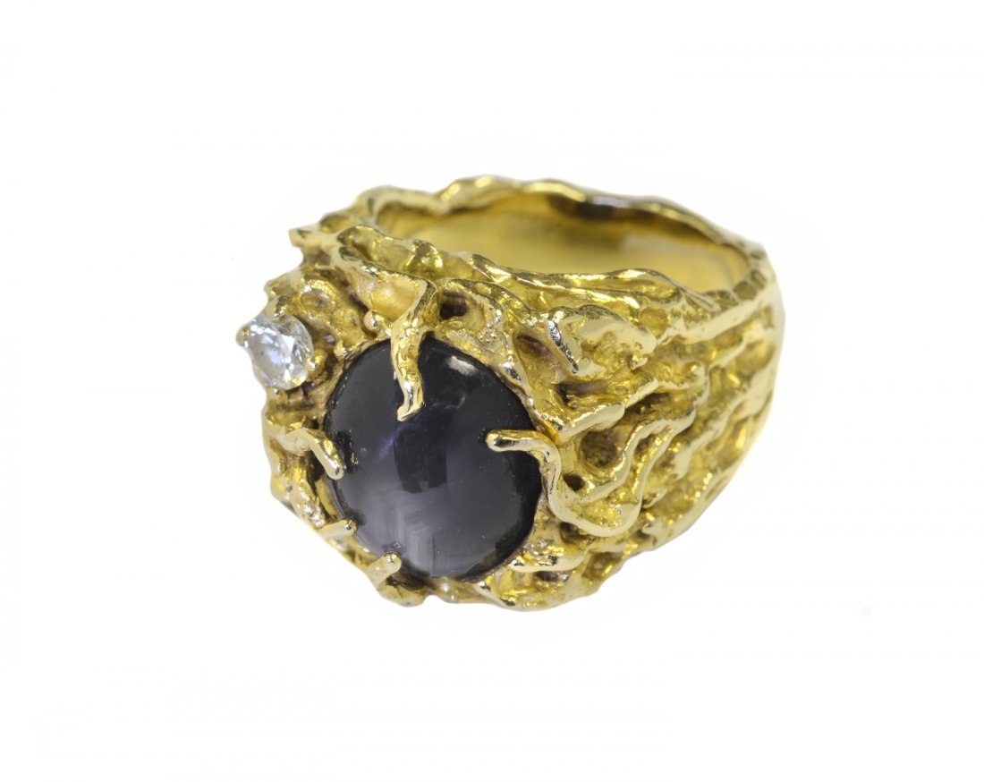 Star Sapphire, Diamond and Gold Ring: From the Collection of Greg Page. Men’s 14-karat gold, star sapphire, diamond and gold “nugget” ring with a grayish blue cabochon sapphire measuring approximately 12 x 10 mm, and one round brill