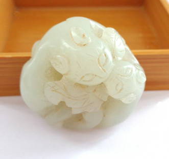 Antique Chinese Jade of Cuddling Chilongs or Kittens: The carving is 360 degrees. The piece measures about 1 1/2" in diameter and is about 1/2" high. It feels very smooth and comfortable in the hand. The color is the same throughout with some of the inci