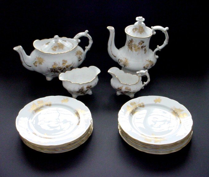 Hammersley Gold and White Tea and Coffee 18 PC Set: The set consists of a teapot, coffeepot, creamer, open sugar bowl, and 12 eight inch dessert/luncheon plates. Gold Thistle pattern.The teapot measures 10 1/2" across from spout to handle edge and is 6