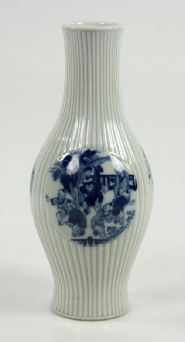 Chinese Olive Shape Blue and White Vase: Chinese olive shape porcelain vase, Kangxi period, with reeded surface, three blue and white roundels, decorated with children playing and officials in discussion, Qing Kanxi mark on base, 10 3/4" hig