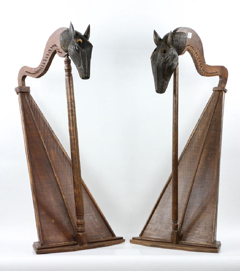 Pr. African Carved Wood Harps: Pair of African carved wood harps, with animal head decoration, 41" h. Provenance: From the estate of a prominent Massachusetts surgeon.