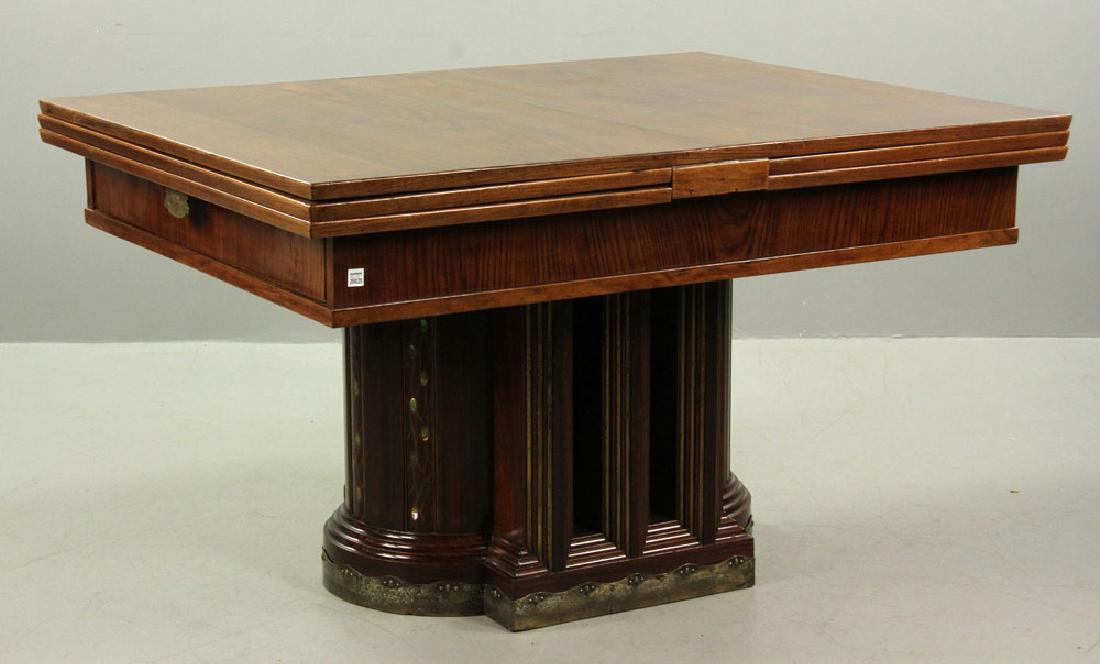 19th C. Vienna Austrian Secessionist Inlaid Table: Vienna Austrian Secessionist table, circa 1890, with fold-out leaves, decorated with mother of pearl inlay and brass edging on base, 32 1/2" h x 55" l x 43 1/2" w (folded), 103" l (extended). Provenan
