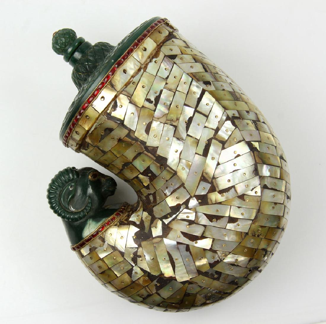 Mughal Carved Jade and Mother of Pearl Container: Mughal carved jade and mother of pearl container, possibly a gunpowder flask, red jeweled trim, one end carved in fish scale pattern, opposite carved with ram's head, 8" h x 6" w. Provenance: From a H