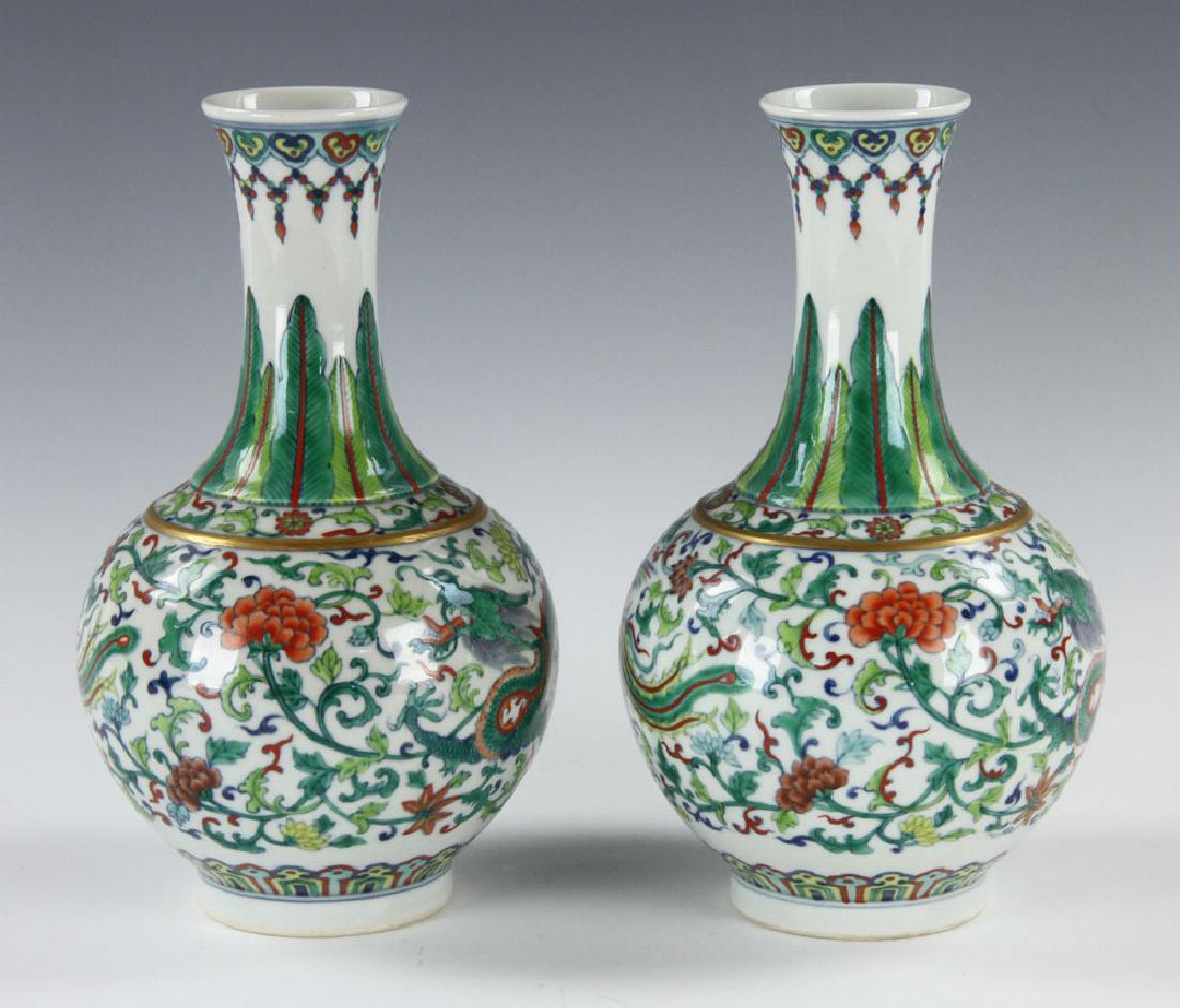Pr. Chinese Qing Dynasty Vases: Pair of Chinese Qing dynasty vases, with dragon, floral plants and birds design, Yongzheng mark on bases, 8 3/4" h x 5" w. Provenance: from Osgood Family.