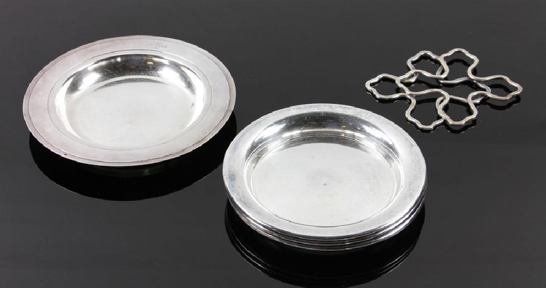 Lot of Ravinet and Christofle Silver Plate Wine: Lot of four Ravinet and Christofle silver plated wine bottle coasters. Provenance: From a Santa Barbara, California estate.