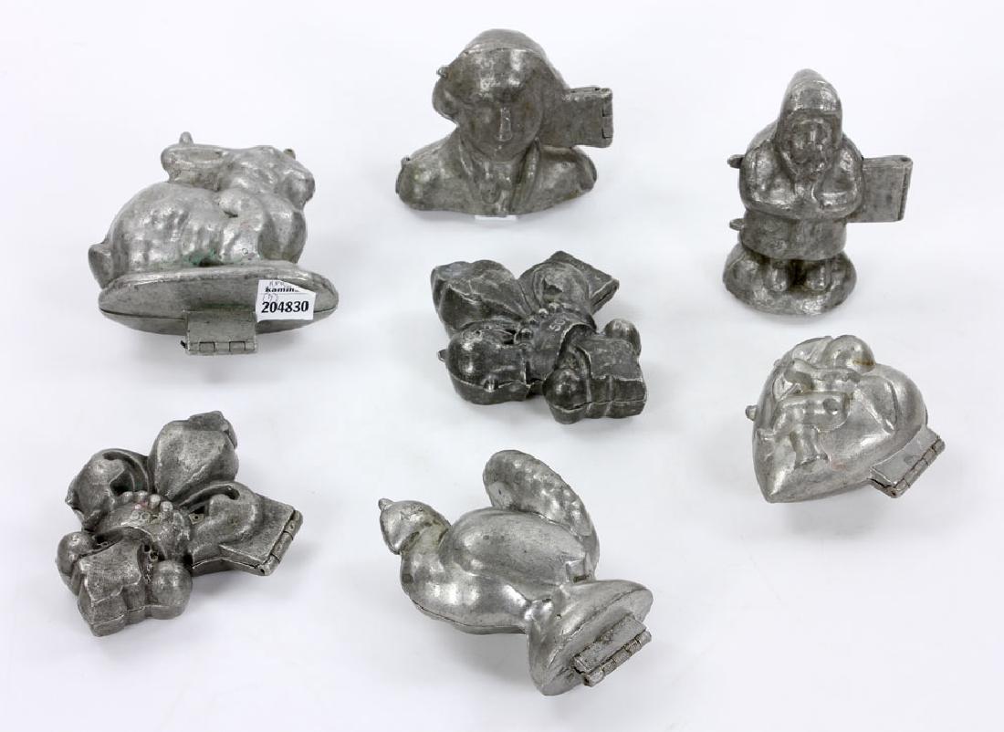 Seven Iron Ice Cream Molds: Lot of seven ice cream molds, iron, including rabbit numbered 958, turkey numbered 429, and a pair of fleur de lis numbered 507. Provenance: from a Jupiter, Florida estate.