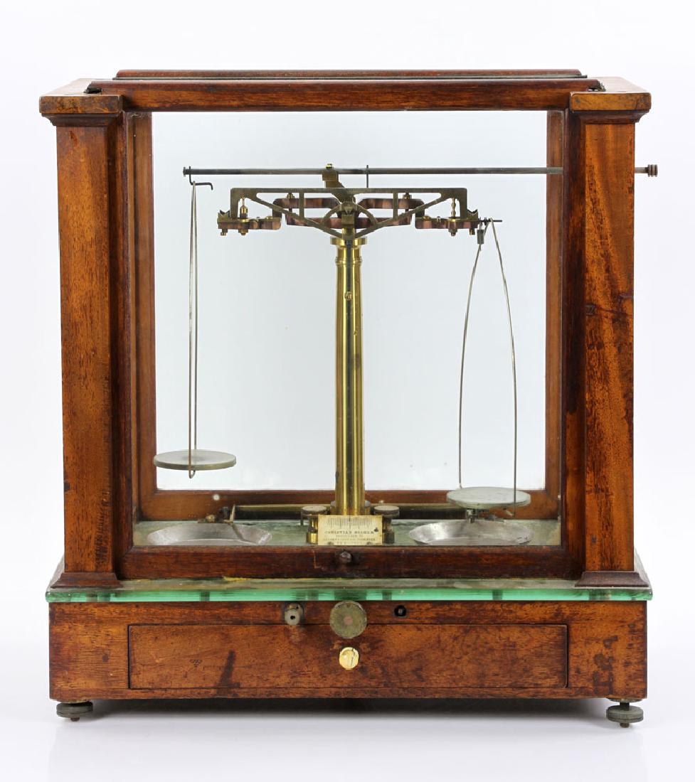 Antique "Christian Becker" Gold Scale: Antique "Christian Becker" gold scale, inclosed in a glass and wood-framed cabinet, 17" h x 15 1/2" w x 9 1/4" d. Provenance: From a Palm Beach collection.