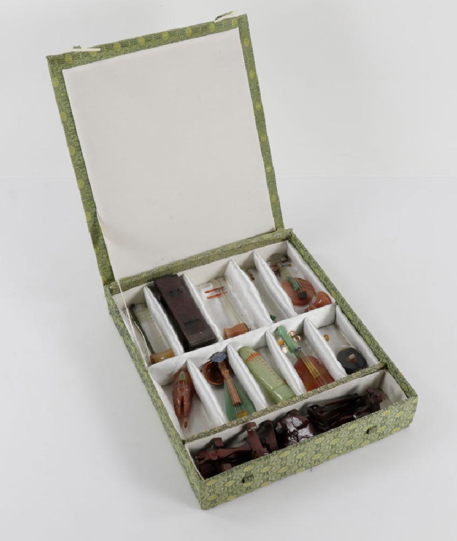 Lot of Chinese Toy Hardstone Instruments: Lot of Chinese toy instruments, including jade and hardstone, with miniature wooden stands, in box, each instrument measuring approximately 4" l. Provenance: From an Andover, Massachusetts estate.The