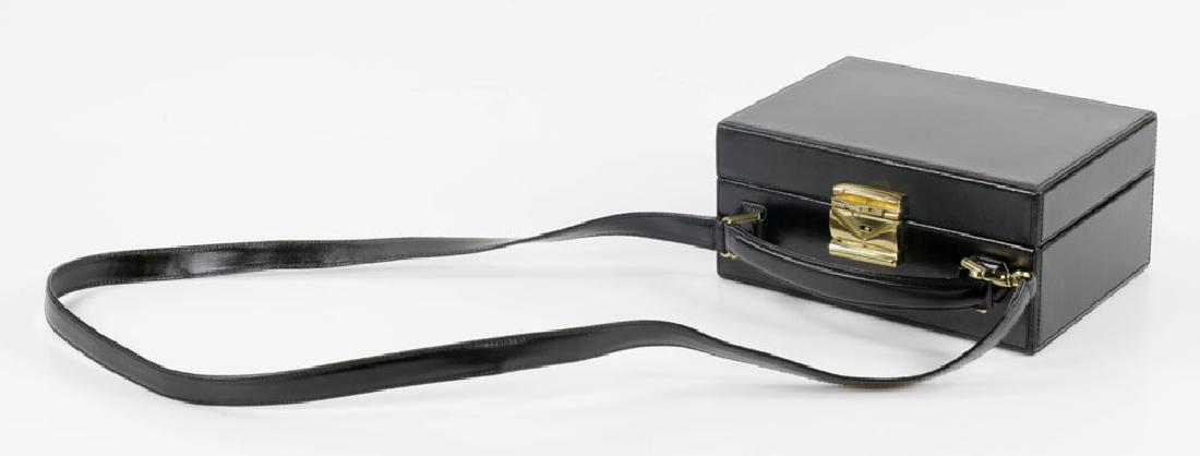 Mark Cross Travel Box Bag: Mark Cross black travel box bag, 8" h x 8 1/4" w, 28" h (including strap). Provenance: From a Palm Beach estate.The absence of a condition report is not an implication that the lot is in perfect condi