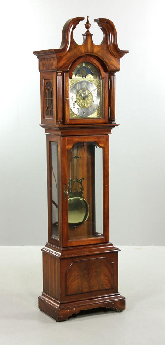 Sligh Grandfather Clock: Sligh grandfather clock, burlwood panel with brass dial and pendulum, split bonnet top, with glass pendulum door, 7' 10" h x 1' 8" w.The absence of a condition report is not an implication that the lo