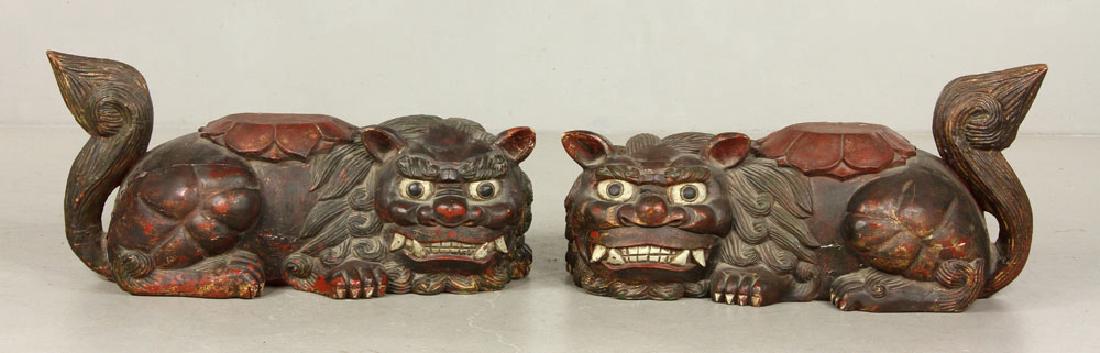 19th C. Pr. Chinese Wooden Foo Dogs: Pair of Chinese foo dogs, 19th century, carved and polychromed wood, 16" h x 33" l x 13" d. The absence of a condition report is not an implication that the lot is in perfect condition or free from im