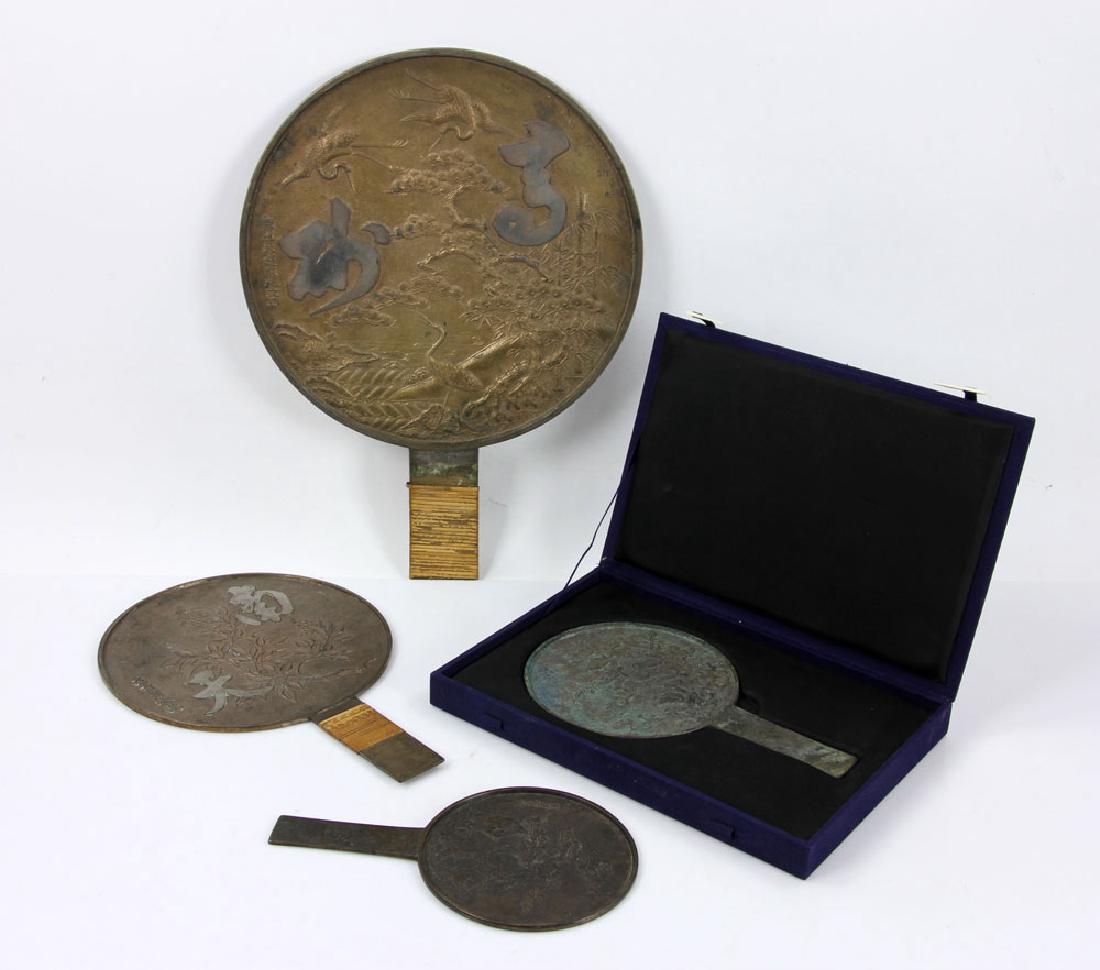 Four Japanese Meiji Vanity Mirrors: Four Japanese Meiji vanity mirrors, bronze, with silver face and handles, carvings on top of mirror and inscriptions, 12" h x 8 1/2" w (larger bamboo wrapped handle), 9 3/4" h x 6" w (blue velvet box)