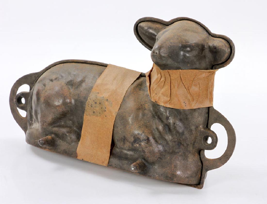 Lamb Cake Mold: Lamb shaped cake mold, iron, 8" high x 14" wide. Provenance: from a Jupiter, Florida estate.The absence of a condition report is not an implication that the lot is in perfect condition or free from im