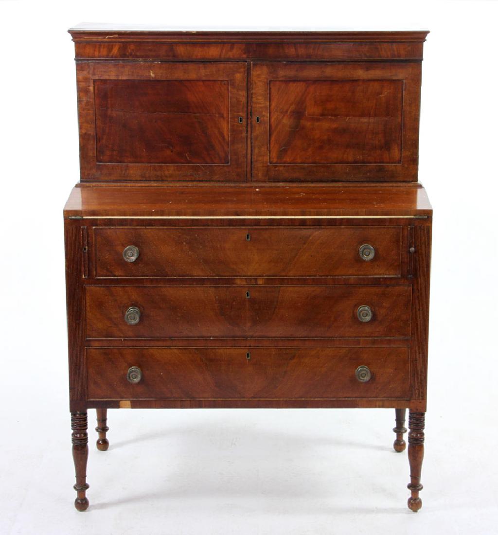 Mahogany Secretary Desk: Federal Sheraton mahogany secretary desk, originally made in the North Shore, Massachusetts, with two door cupboard and slant lid desk above three long drawers, 52" h x 38 1/2" w x 19 1/2" d.